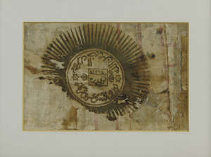 
	
		An Islamic textile fragment, with calligraphy within a circular sun device, framed and...