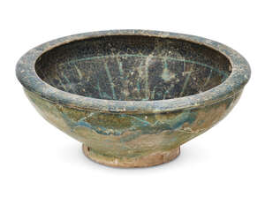 
	
		An Iranian bowl, the interior covered with greenish blue glaze with a band of pale blue...