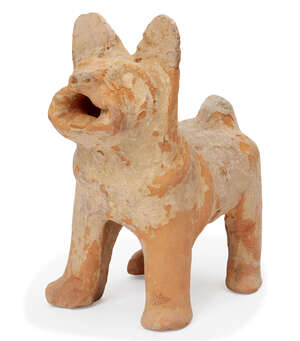 
	
		A Chinese pottery model of a dog, Han dynasty, standing foursquare with its head raised...