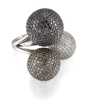 
	
		A diamond and coloured diamond dress ring, composed of three graduated spheres, pavé set...