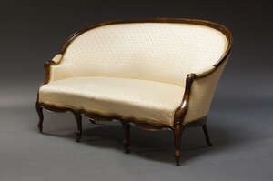 
	
		A French walnut framed canapé, late 19th Century, the curved rounded back with cream silk...