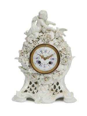
	
		A Continental white porcelain clock, late 19th century, the top applied with a cherub and...