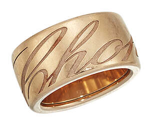
	
		A 'Chopardissimo' ring, by Chopard, the revolving wide band inscribed 'Chopard' in italic...