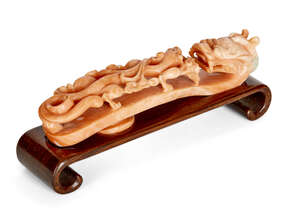 
	
		A Chinese coral 'dragon' belt hook, 18th century, carved with dragon head terminals and...