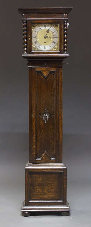 
	
		An Edwardian oak grandmother clock, early 20th century, with plain case, the brass dial...