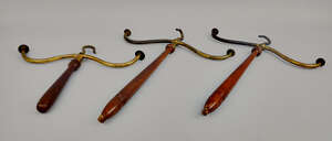 
	
		A pair of brass and mahogany coat hangers, late 19th/early 20th century, 41cm high,...