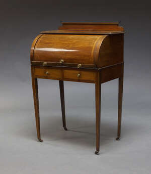 
	
		An Edwardian mahogany and line inlaid cylinder bureau, the top with shaped superstructure...