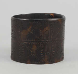 
	
		A Sepik tortoiseshell cuff bangle, incised with bands of geometrical stellar designs,...