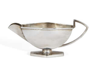 An Art Deco silver milk jug on hexagonal foot, Birmingham, c.1934, Roberts & Dore, of elongated hexagonal form with squared lip, 15cm long, 7cm high, 3.9oz