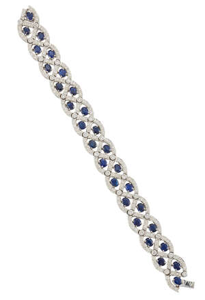 
	
		A  diamond and sapphire flexible bracelet, composed of circular-cut diamond lattice-work...