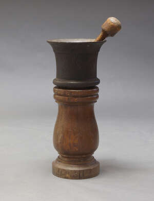 
	
		A large cast iron mortar, probably 18th century, 28cm high, together with a turned wood...