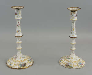
	
		A pair of Bilston enamel candlesticks, c 1750, decorated with floral sprays and to the...