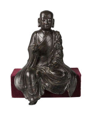 
	
		A Chinese bronze seated Lohan, Ming dynasty, 16th/17th century, seated at 'Royal Ease',...