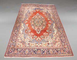 
	
		A Heriz carpet, mid 20th Century, with floral and foliate oval medallion in red field,...