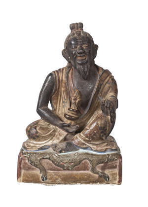 
	
		A Tibetan painted terracotta figure of Mahasiddha, early 19th century, depicted seated on...
