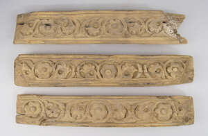 
	
		A set of three Islamic carved wooden panels, decorated with trails of flower heads and...