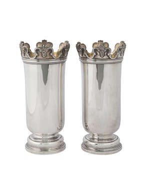 A pair of late Victorian silver vases, London c.1900, Daniel & John Wellby, of slightly flared cylindrical form, with moulded castellated rim, on shaped circul
