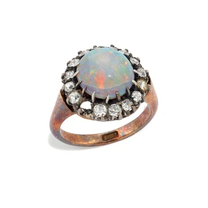 An opal and diamond cluster ring, set with an opal cabochon, within old-cut diamond surround, to plain tapered hoop, stamped 18ct, ring size G (VAT charged on 