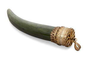 
	
		A silver-mounted jade tooth, India, 20th century, the curved tooth with a gilded silver...