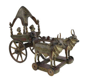  
A polychrome lacquered painted wooden carriage drawn by oxen, India, early 19th century, the...
