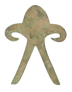 A copper anthropomorphic figure, India, Gangentic plains, 2nd millenium B.C., cast with a domical head, long outstretched arms that curl inwards, and splayed l