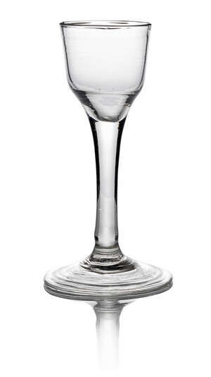A George III drinking glass, with bucket form bowl on clear stem, on fold over foot, 14.5cm high