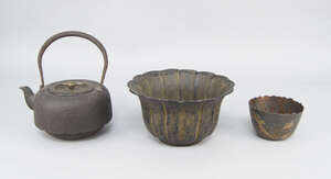 
	
		A Japanese cast iron kettle, Tetsubin, the body moulded with leaf forms, with swing...