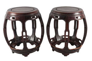 
	
		A pair of Chinese hardwood barrel form stools, early 20th century, with pierced supports,...