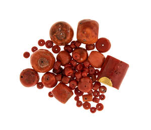 
	
		A small collection of coral beads, comprising four large barrel shaped coral corallium...