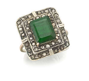 
	
		An emerald and diamond cluster ring,  the single rectangular-cut emerald in claw-set...