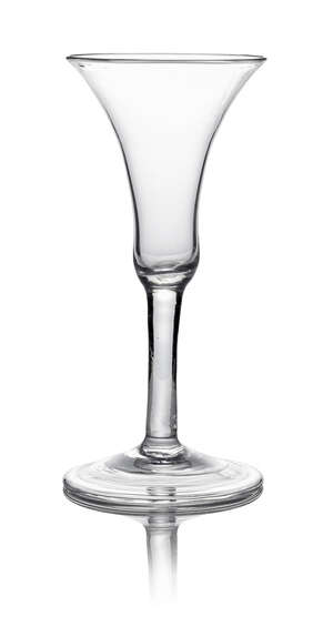 A George III drinking glass, with trumpet form bowl, on clear stem, with spreading fold over foot, 16.5cm high