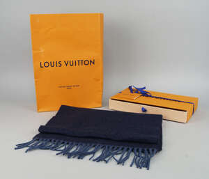 
	
		A Louis Vuitton navy blue cashmere scarf, logo to one side, in original box and carrier...