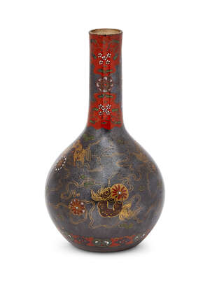 A Chinese porcelain monochrome bottle vase, 17th century, covered with a black silver-speckled glaze, later decorated in gilt and enamels with Buddhist lions, 