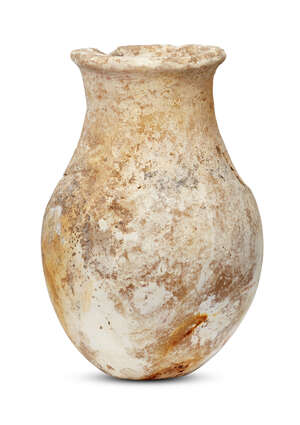 A Bactrian alabaster vessel, 3rd millennium B.C., on a narrow foot rising to a pear-shaped body and a slightly everted rim, 12cm high
		 
