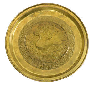 Keswick School of Industrial Art, a large brass Charger
		c.1900, stamped K.S.A.I.
		Embossed in the centre with a peacock and foliage, enclosed by a peacock