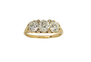 
	
		A Victorian diamond three stone ring, of half-hoop design composed of three cushion...