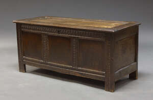 
	
		A 17th Century oak coffer, the front with three panels, bordered by carved guilloche...