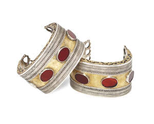 
	
		A pair of brass and silver Turkoman Tekke cuffs, with openwork circular terminals, the...