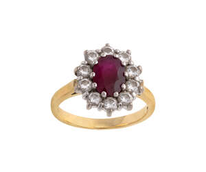 
	
		A ruby and diamond ring, cluster design, centring on an oval ruby surrounded by...