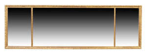 A George III style carved giltwood overmantel mirror, 19th century and later, with a triple...