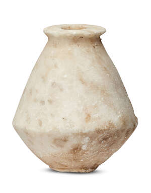 A Bactrian marble vessel, 3rd millennium B.C., on a narrow foot, widening at the waist and narrowing towards the flat disc rim, 11.5cm. high
		 
		Provenanc