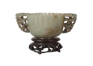 
	
		A Chinese green jade twin-handled lobed cup, Ming dynasty, 16th century, with reticulated...