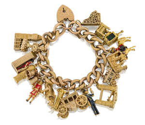 A charm bracelet, the late 19th / early 20th century partially engraved gold curb link bracelet suspending mostly 9ct gold charms, including: a grand piano; To