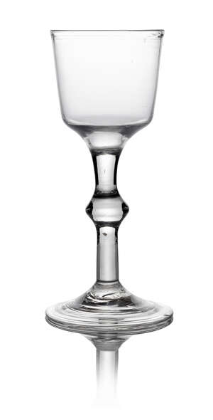 A George III drinking glass, the bucket form bowl, with clear sign knop stem, on spreading fold over foot, 15.9cm high
