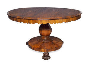 
	
		A Regency rosewood tilt top breakfast table, the circular top on baluster form column...