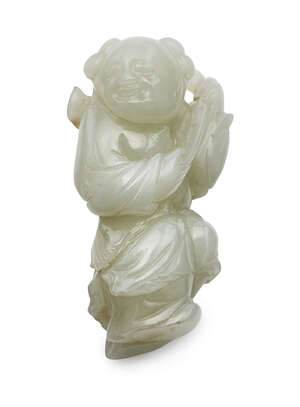 
	
		A Chinese pale celadon carving of a boy, 18th century, carved standing, holding a lingzhi...