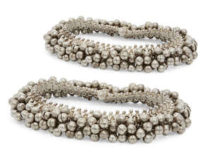 
	
		A pair of silver anklets, India, 20th century, composed of a series of panels fringed...