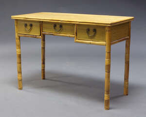 
	
		A modern bamboo desk, of recent manufacture, the rectangular top above three frieze...