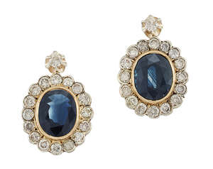 A pair of sapphire and diamond cluster earrings, each oval-cut sapphire in collet mount with circular-cut diamond border and diamond single stone surmount, pos