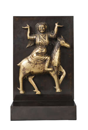 
	
		A Tibetan gilt copper repousse plaque, 17th/18th century, modelled with a tantric...